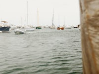 a boat is in the water near a pier